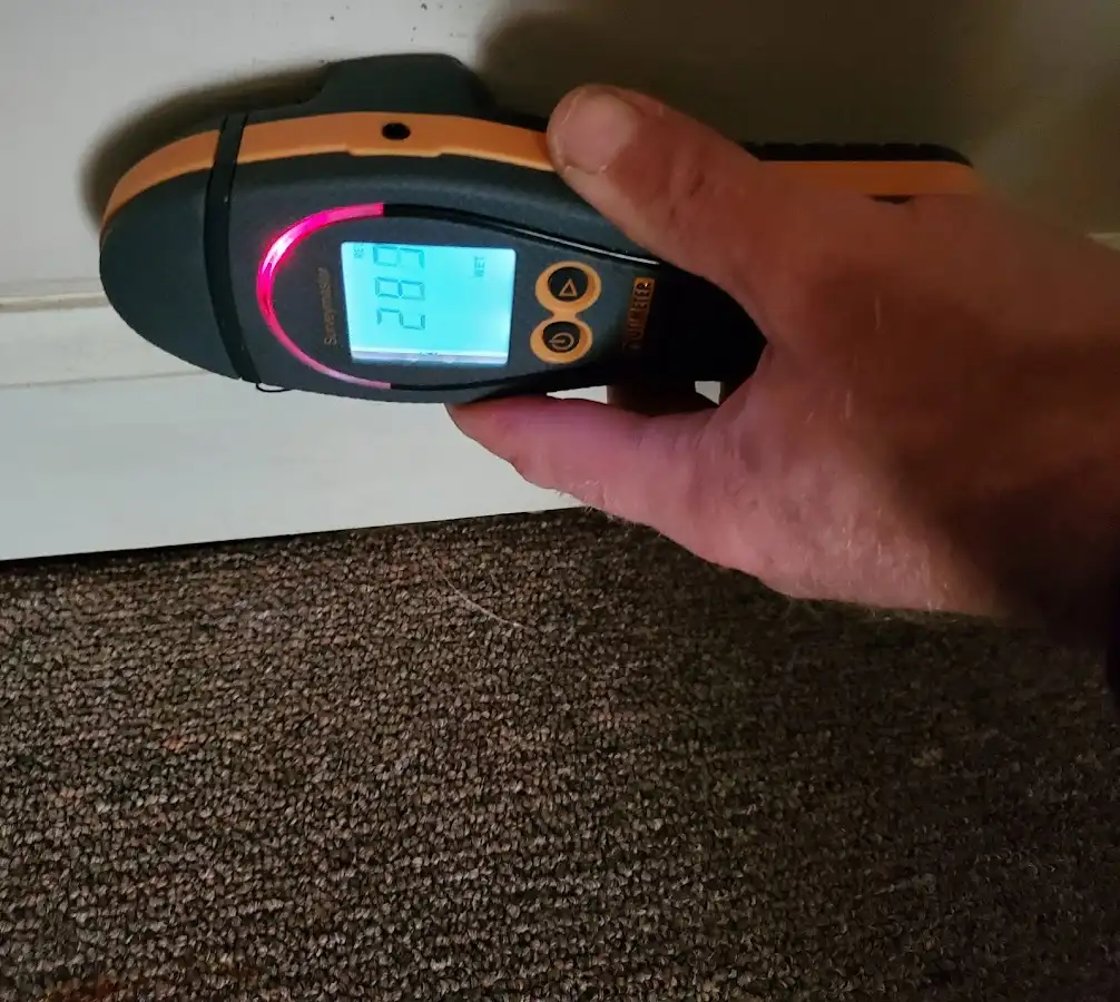 Moisture detection at baseboard during Storm Damage Restoration in Hillside